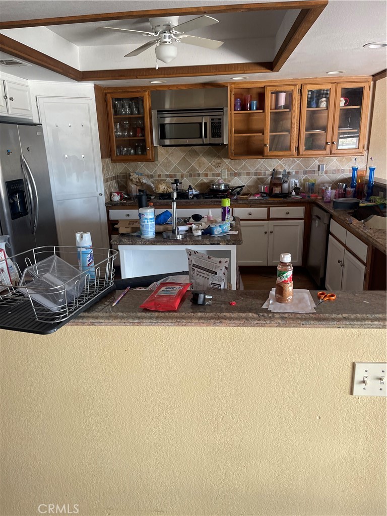 23859 Papago Road Apple Valley, CA 92307 - Photo 8 of 32 a kitchen with stainless steel appliances granite countertop a sink and a stove