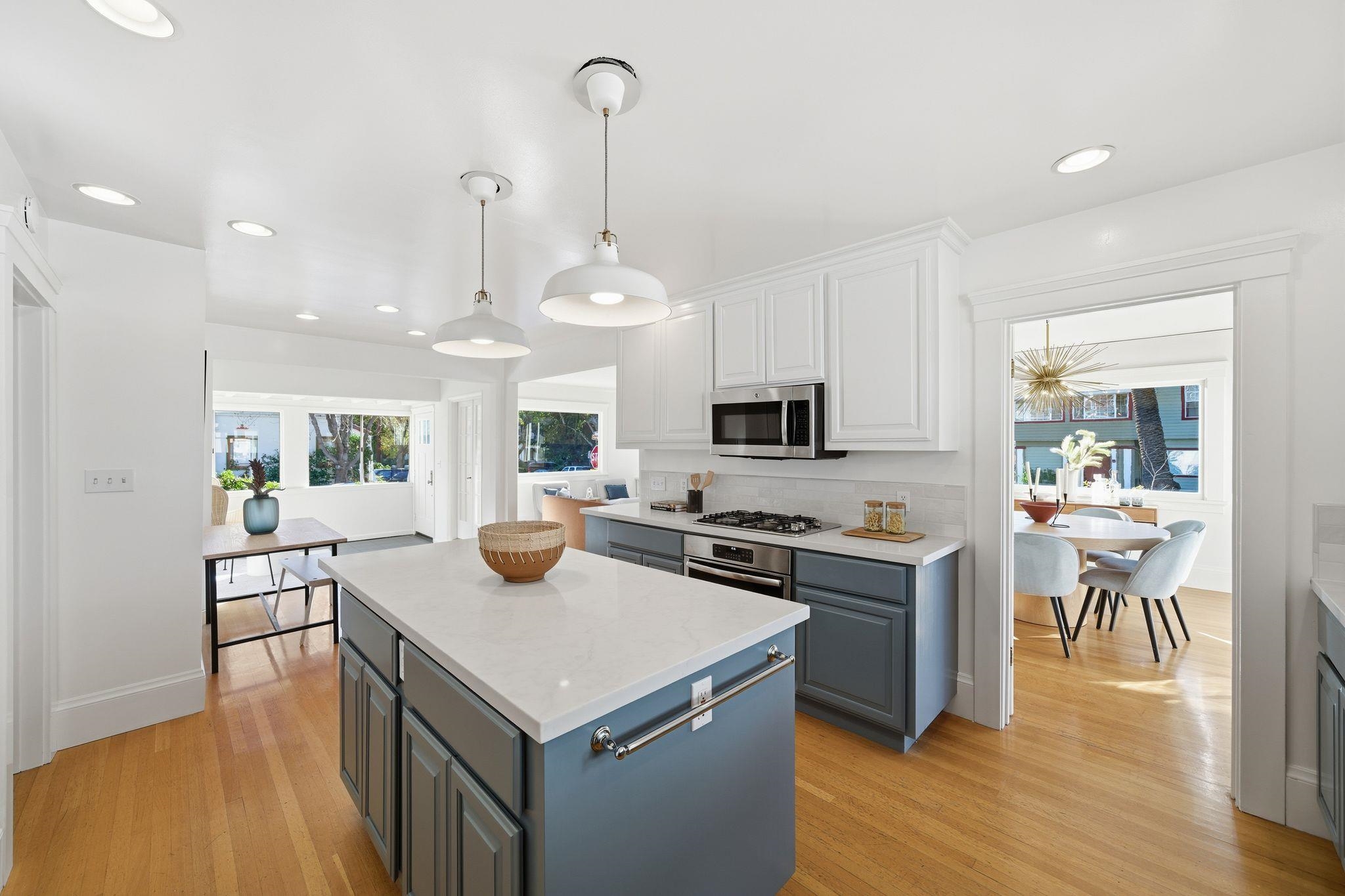 2401 Carleton Street Berkeley, CA 94704 - Photo 13 of 46 Kitchen featuring white cabinetry, hanging light fixtures, light wood-type flooring, a center island, and recessed lighting