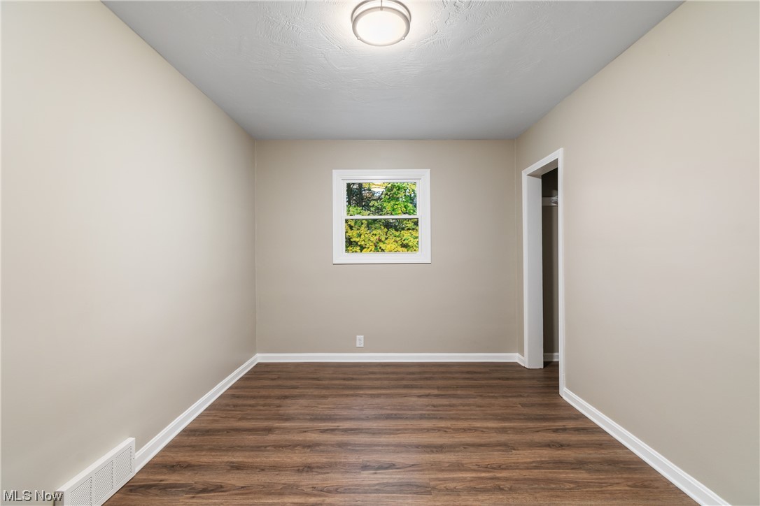 916 Renninger Road Akron, OH 44319 - Photo 18 of 31 Empty room with dark wood-type flooring