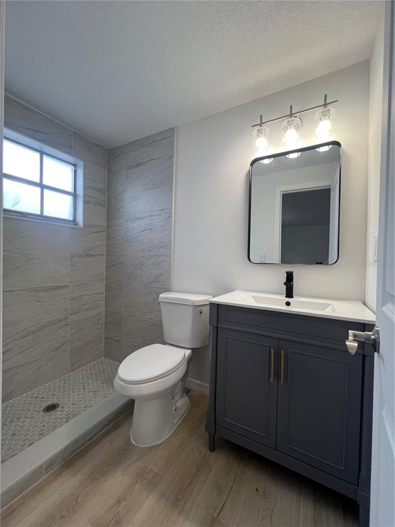 4223 Sheldon Place, Unit 23 New Port Richey, FL 34652 - Photo 11 of 13 a bathroom with a sink toilet and shower