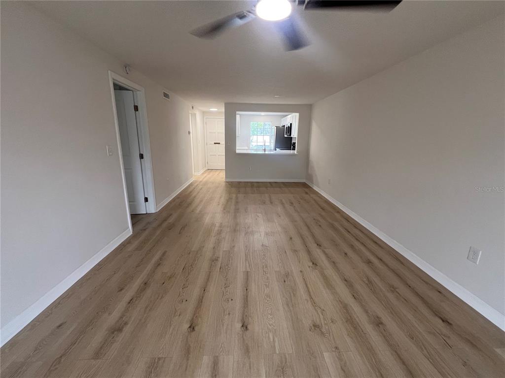 4223 Sheldon Place, Unit 23 New Port Richey, FL 34652 - Photo 12 of 13 wooden floor in an empty room with a window