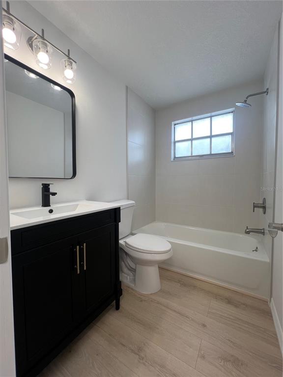 4223 Sheldon Place, Unit 23 New Port Richey, FL 34652 - Photo 6 of 13 a bathroom with a sink a toilet and mirror