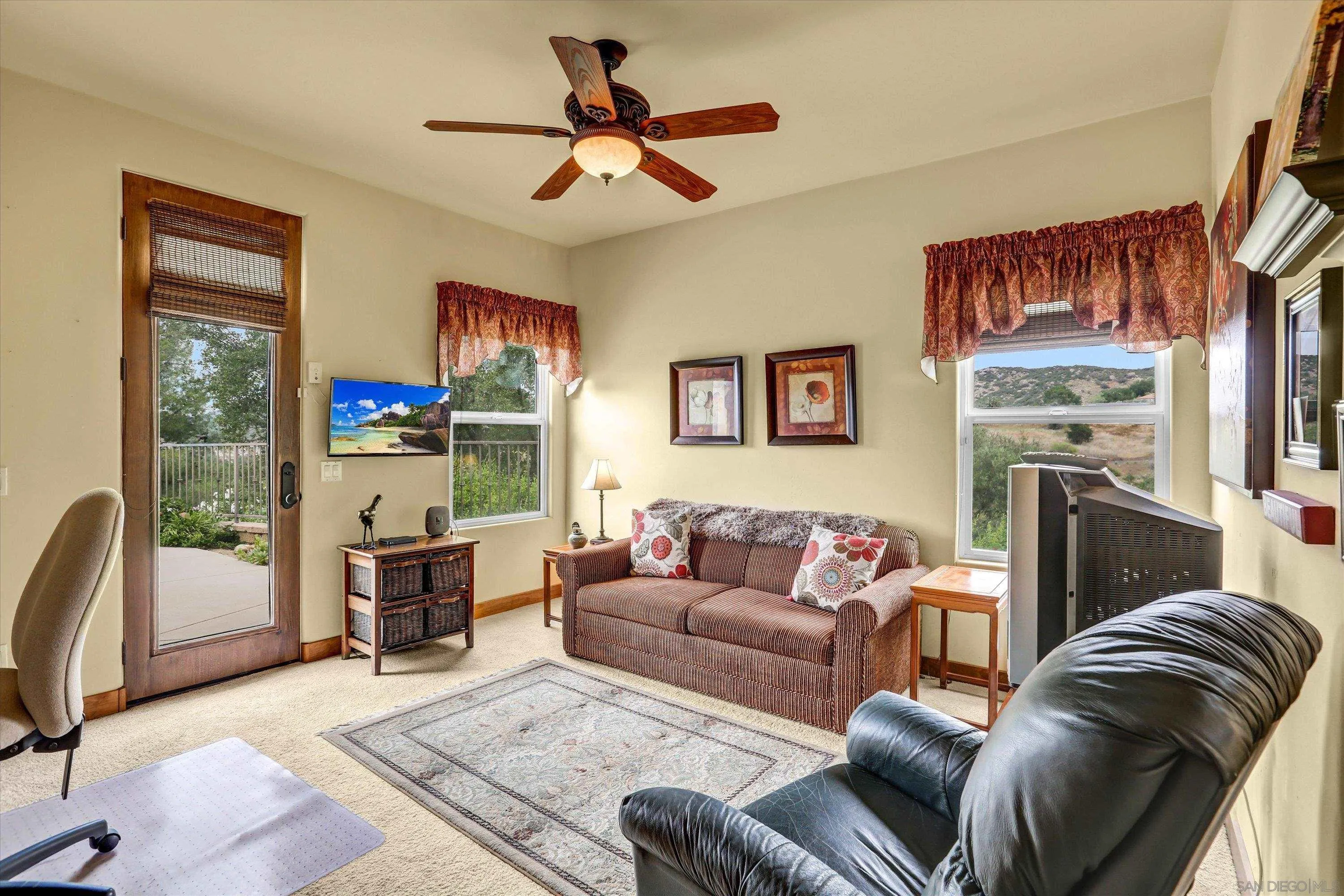 584 South Grade Road Alpine, CA 91901 - Photo 30 of 39 a living room with furniture a window and a fireplace