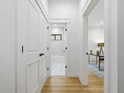 a view of a hallway with wooden floor and staircase
