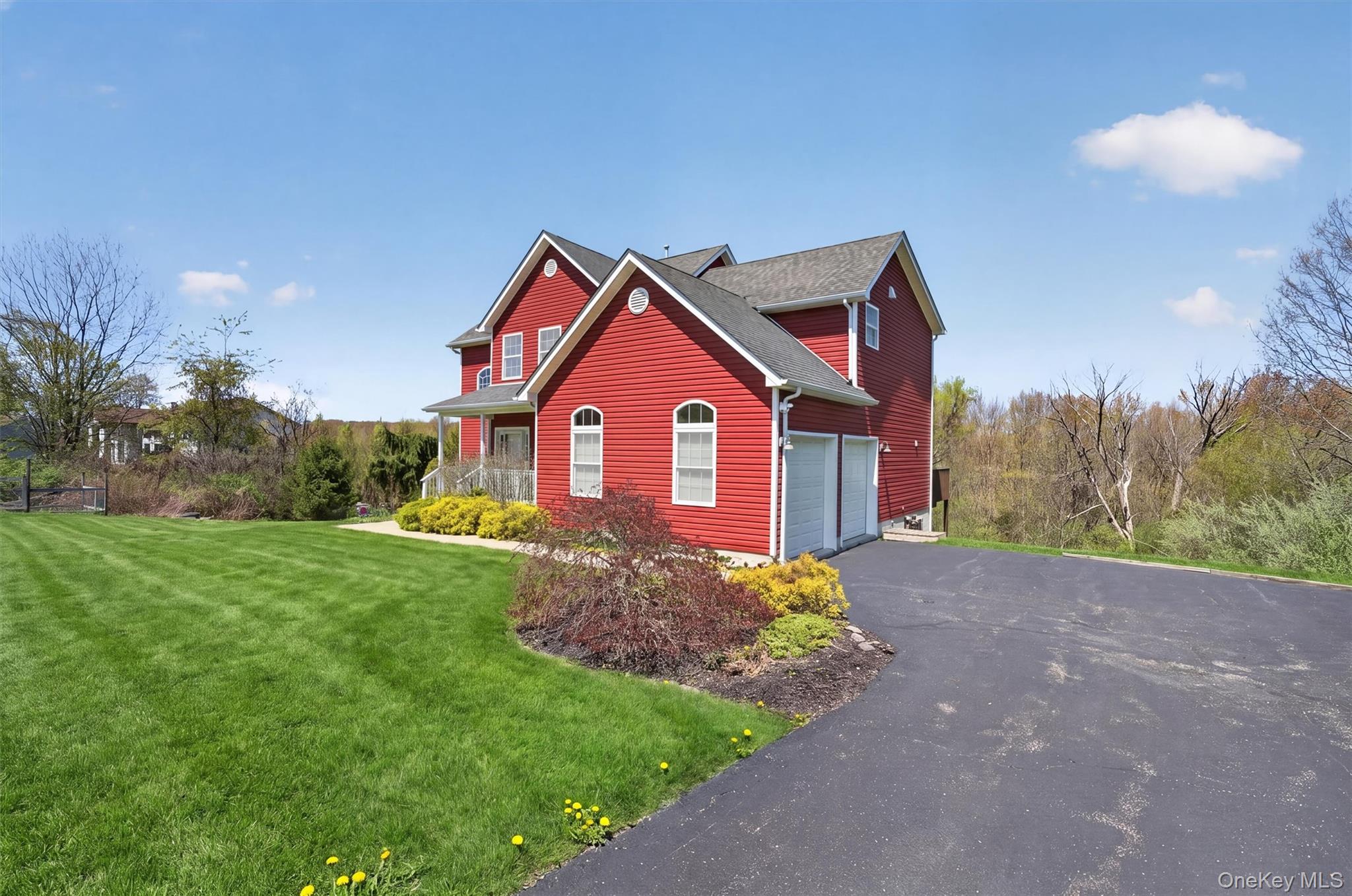 2 Primrose Lane Chester, NY 10918 - Photo 2 of 42 a front view of a house with a yard and garage