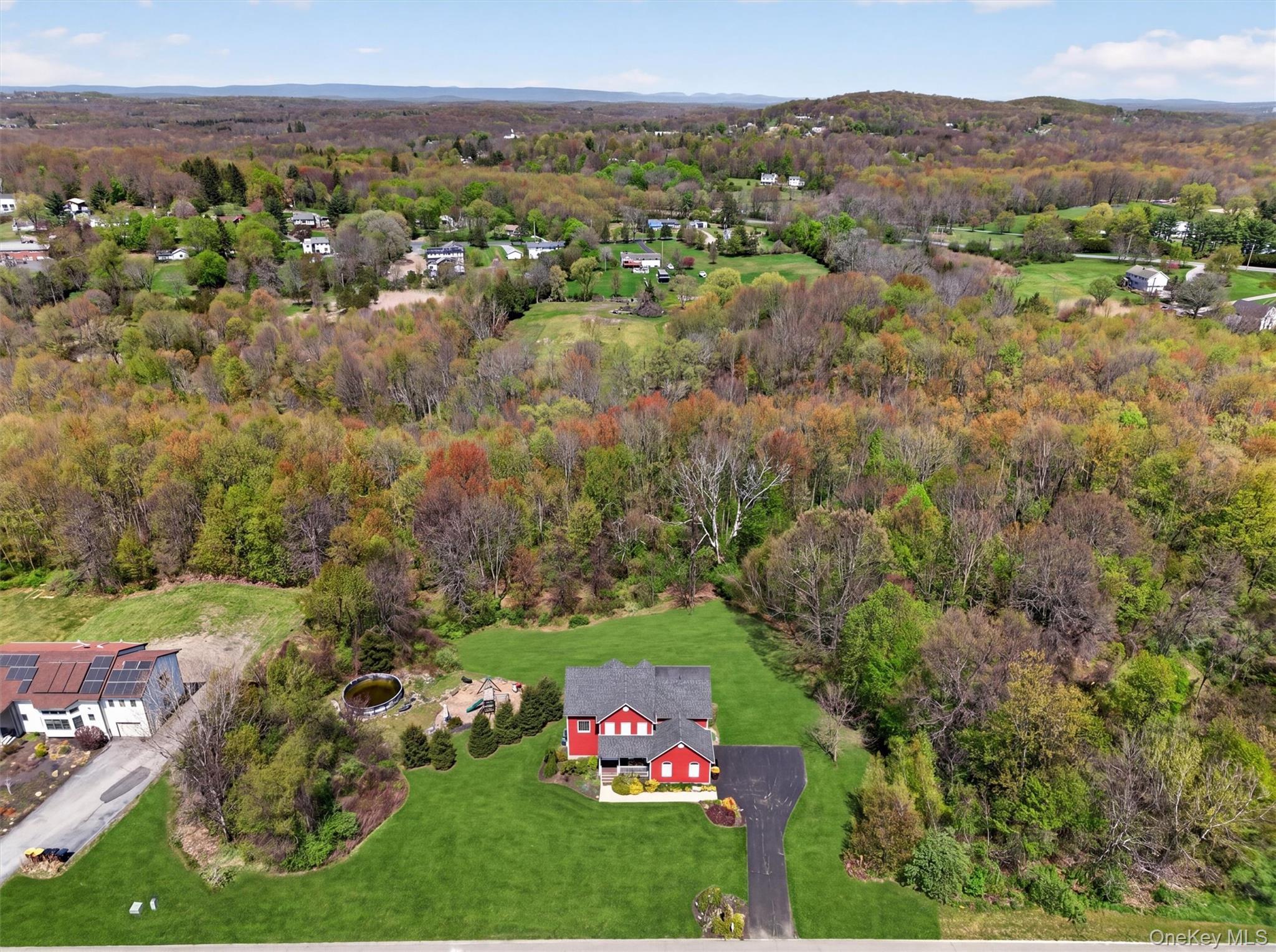 2 Primrose Lane Chester, NY 10918 - Photo 3 of 42 an aerial view of green landscape with trees houses and mountain view