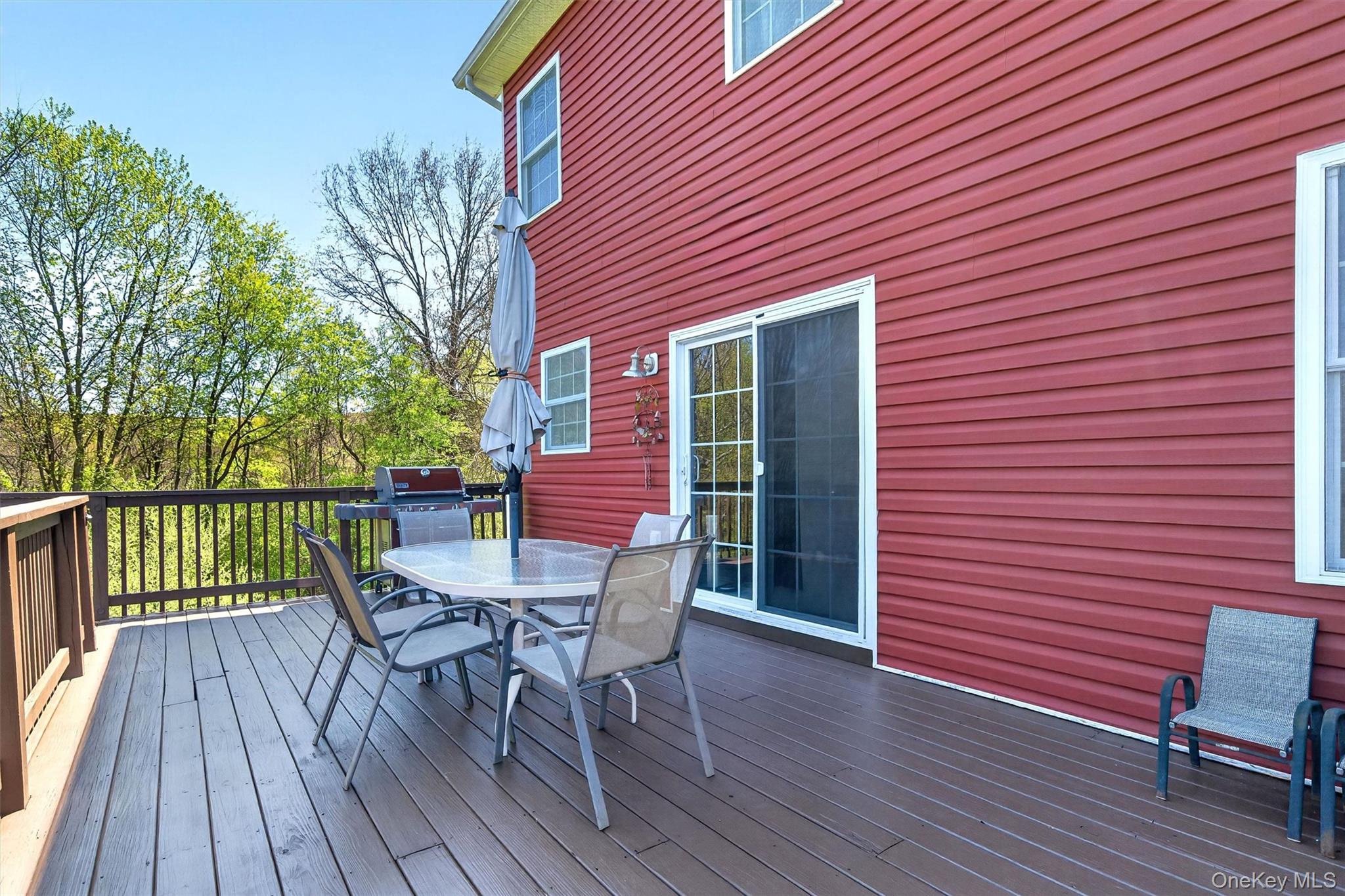 2 Primrose Lane Chester, NY 10918 - Photo 32 of 42 a view of a patio with table and chairs with wooden floor and fence
