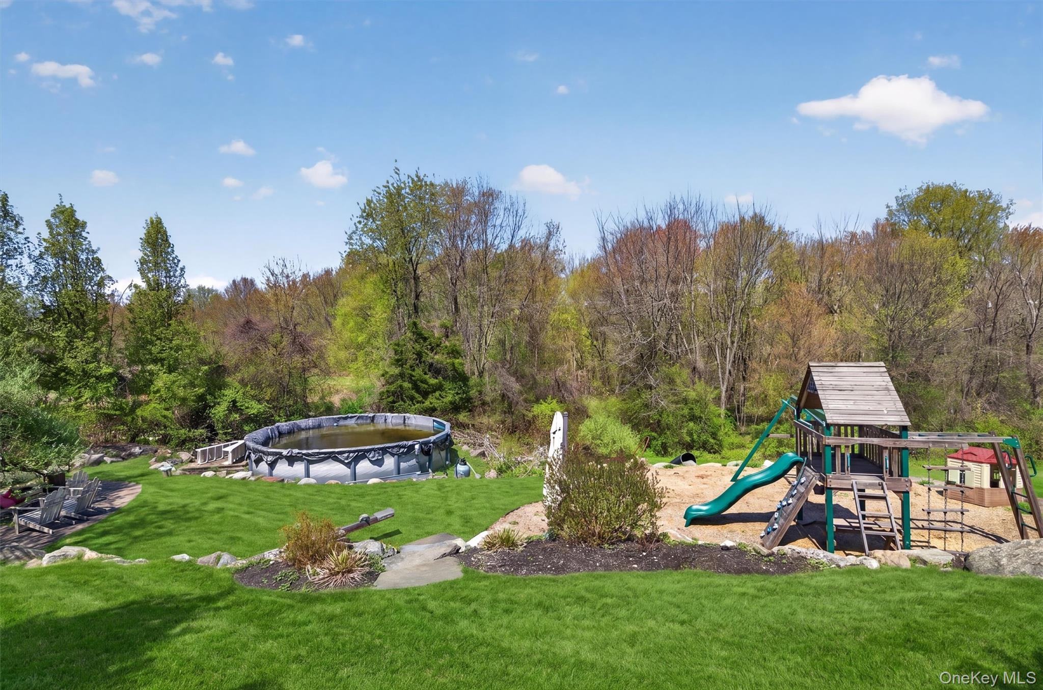 2 Primrose Lane Chester, NY 10918 - Photo 34 of 42 a view of a garden with a building in the background