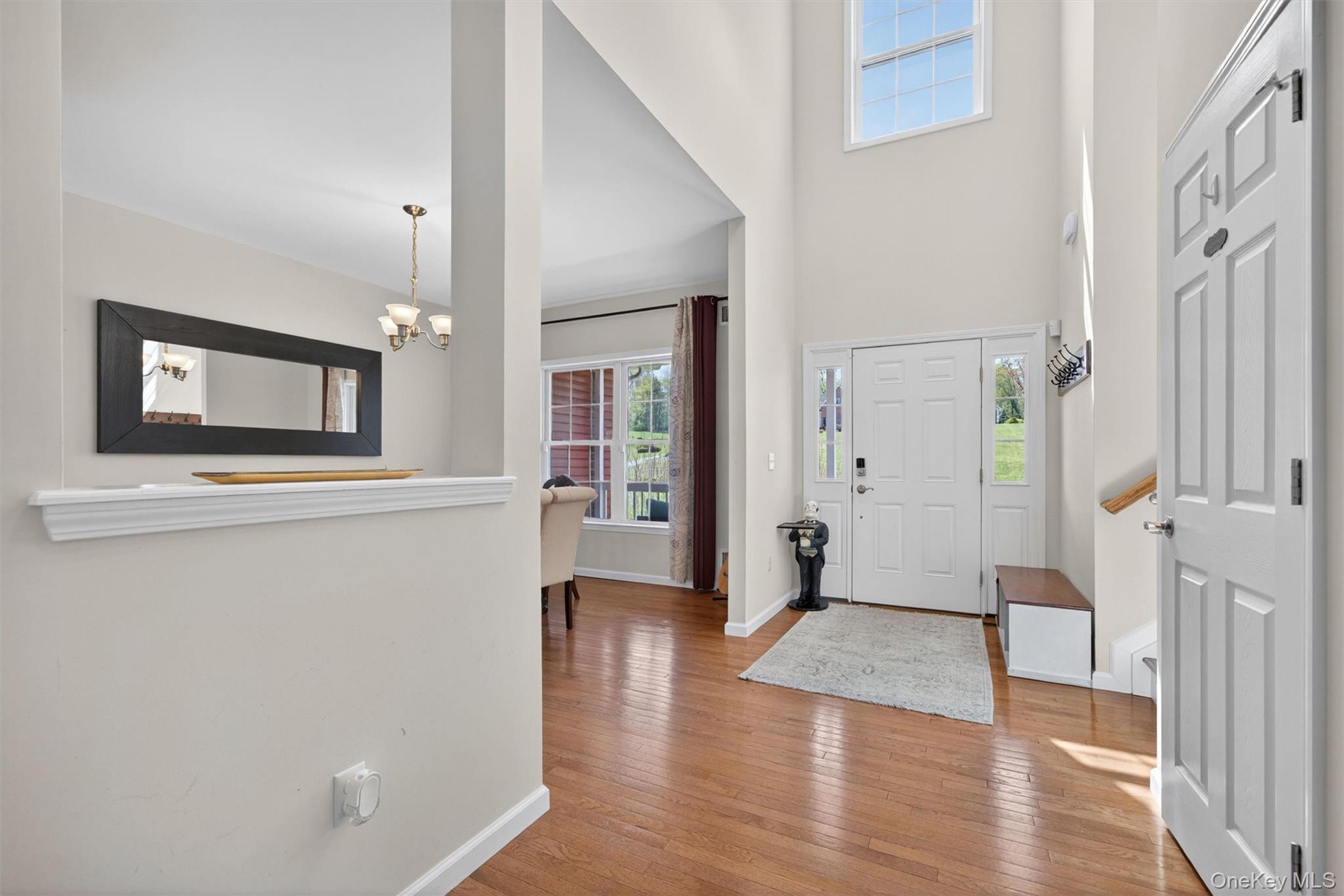2 Primrose Lane Chester, NY 10918 - Photo 9 of 42 a view of a hallway with wooden floor and a living room