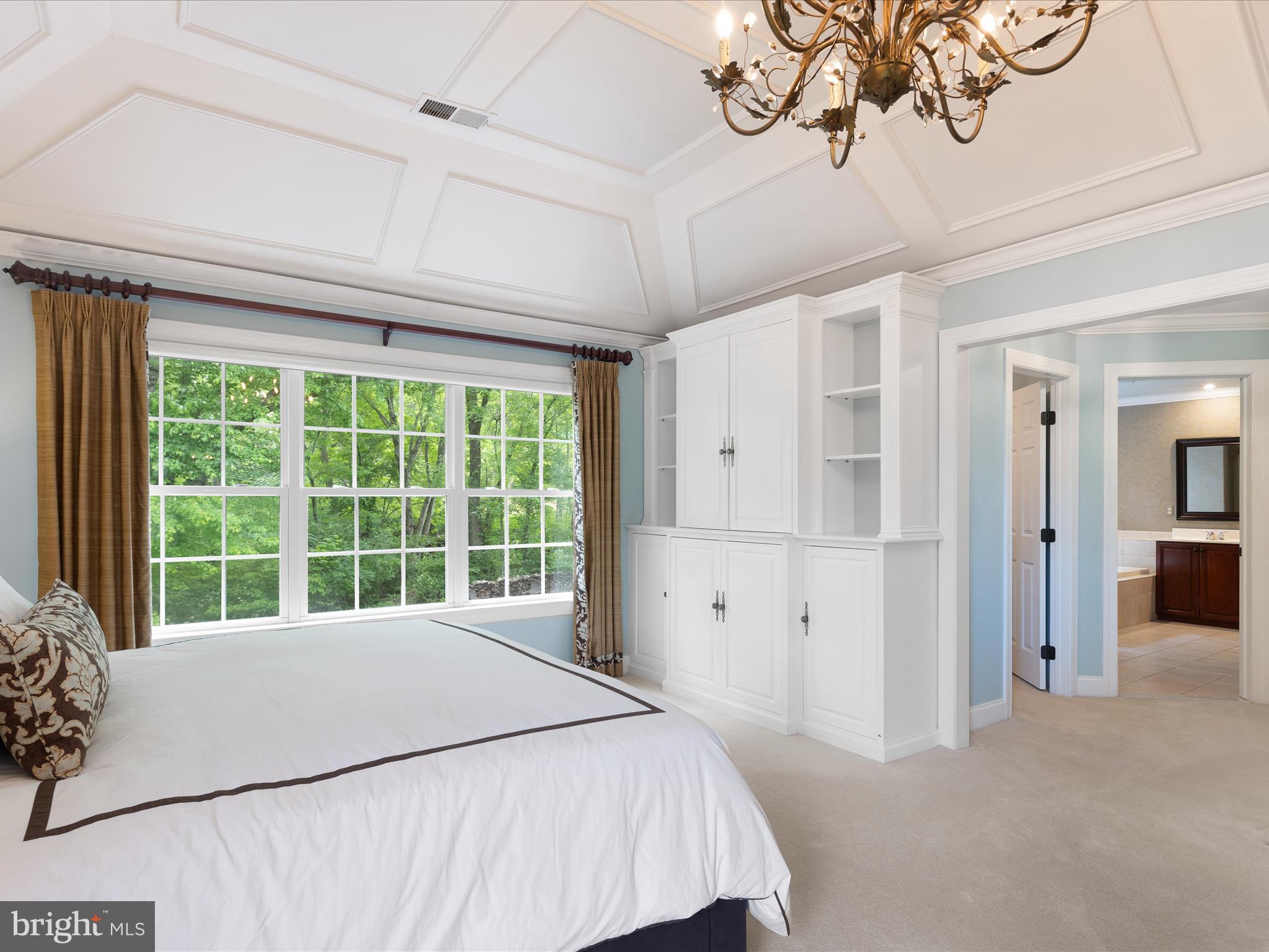 130 Waterfall Lane Landenberg, PA 19350 - Photo 21 of 49 a bedroom with a large bed and a chandelier