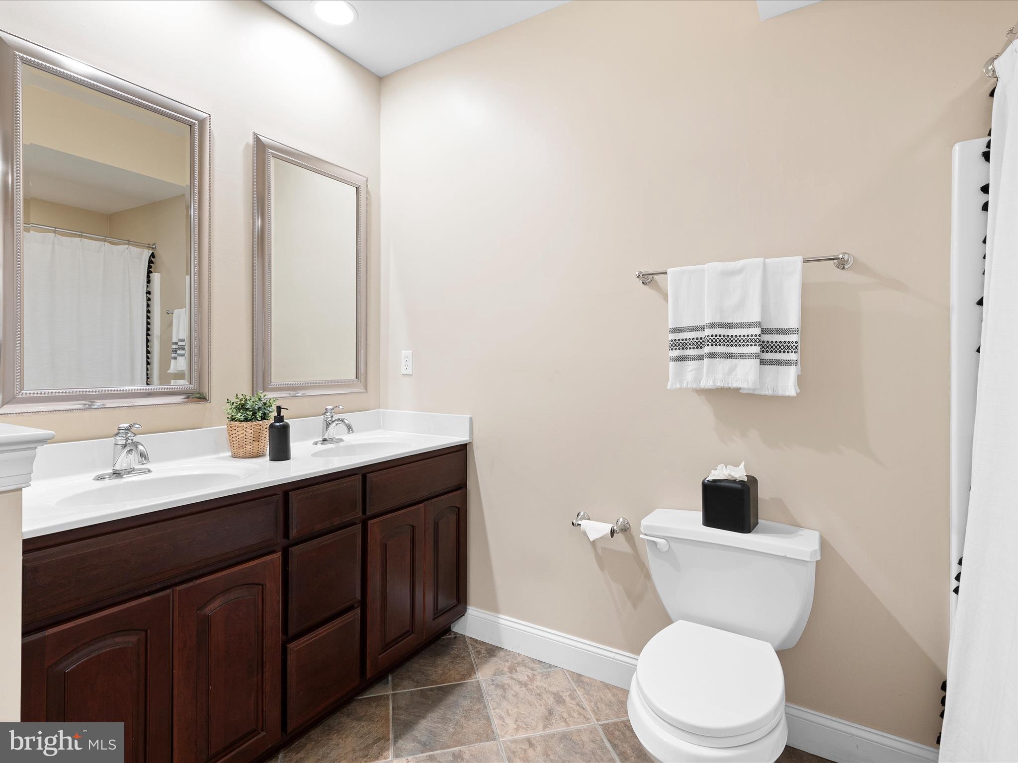130 Waterfall Lane Landenberg, PA 19350 - Photo 40 of 49 a bathroom with a toilet a sink a mirror and a window