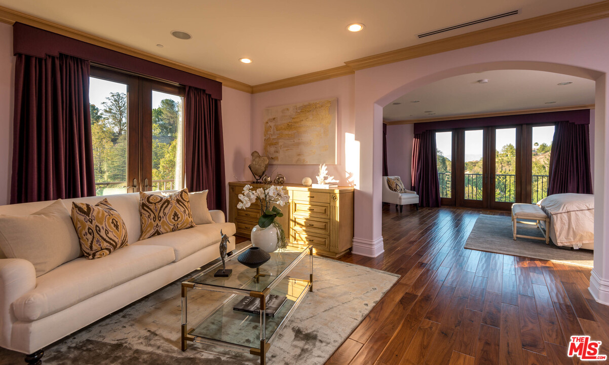 4775 Topeka Drive Tarzana, CA 91356 - Photo 11 of 19 a living room with furniture and wooden floor