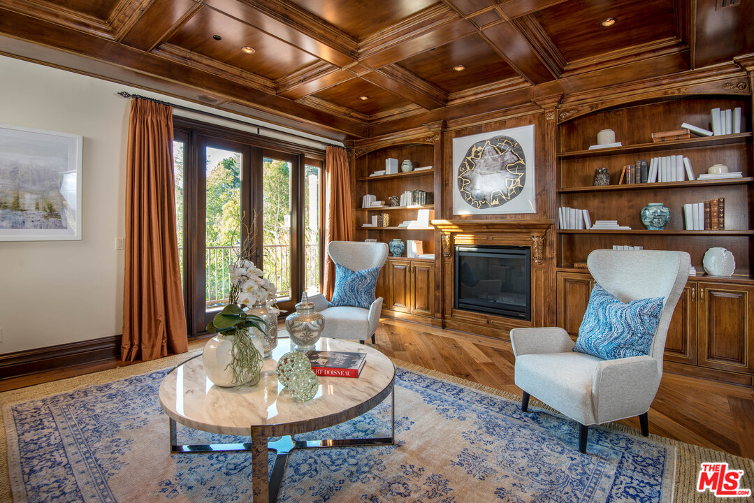 4775 Topeka Drive Tarzana, CA 91356 - Photo 12 of 19 a living room with furniture a rug a fireplace and a chandelier