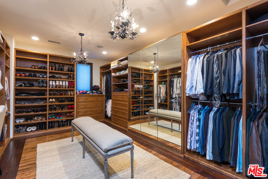 4775 Topeka Drive Tarzana, CA 91356 - Photo 13 of 19 a view of walk in closet with clothes and shoes