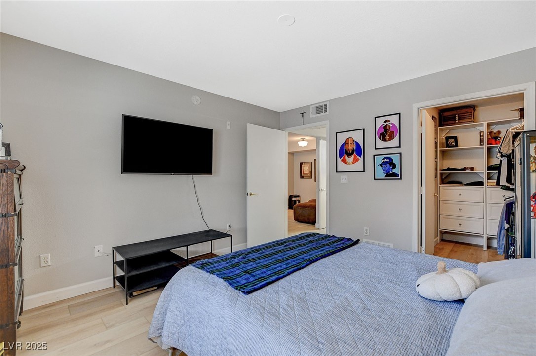 555 East Silverado Ranch Boulevard, Unit 1172 Las Vegas, NV 89183 - Photo 23 of 29 Bedroom featuring a spacious closet and light wood-type flooring