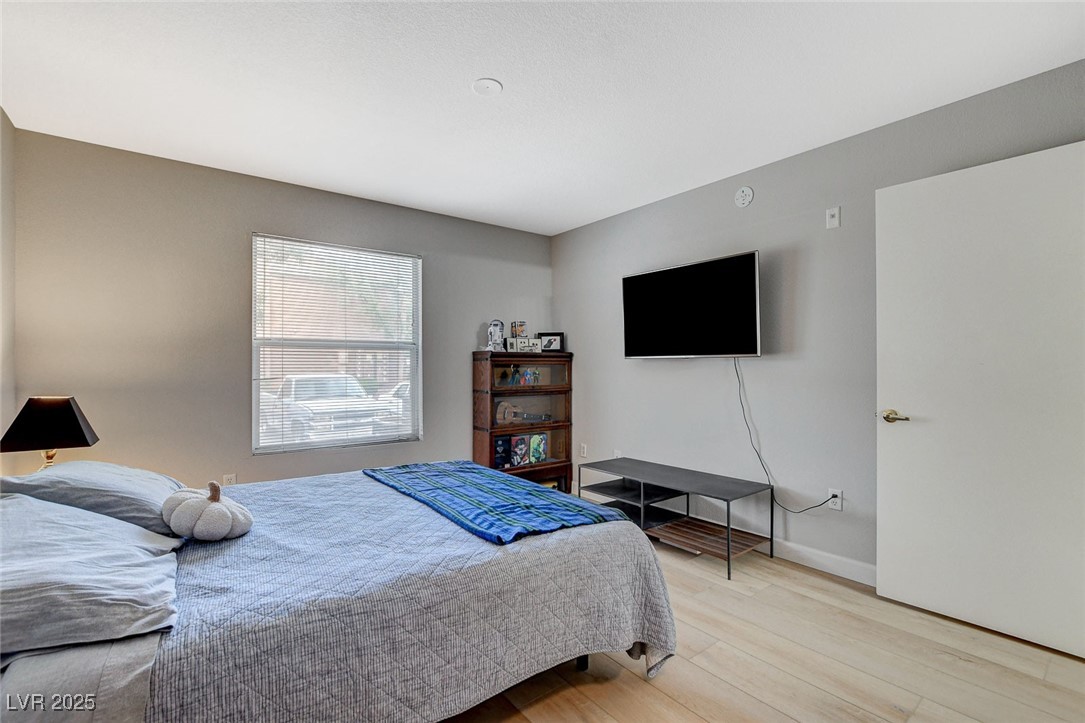 555 East Silverado Ranch Boulevard, Unit 1172 Las Vegas, NV 89183 - Photo 24 of 29 Bedroom featuring wood finished floors and baseboards