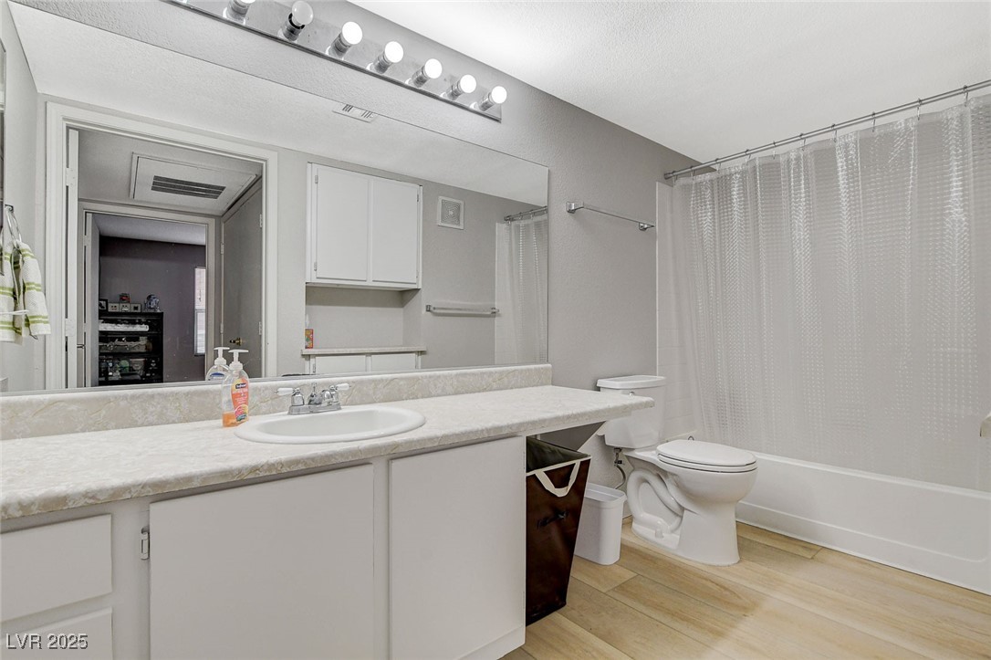 555 East Silverado Ranch Boulevard, Unit 1172 Las Vegas, NV 89183 - Photo 25 of 29 Full bath with vanity, light wood finished floors, and shower / bathtub combination with curtain