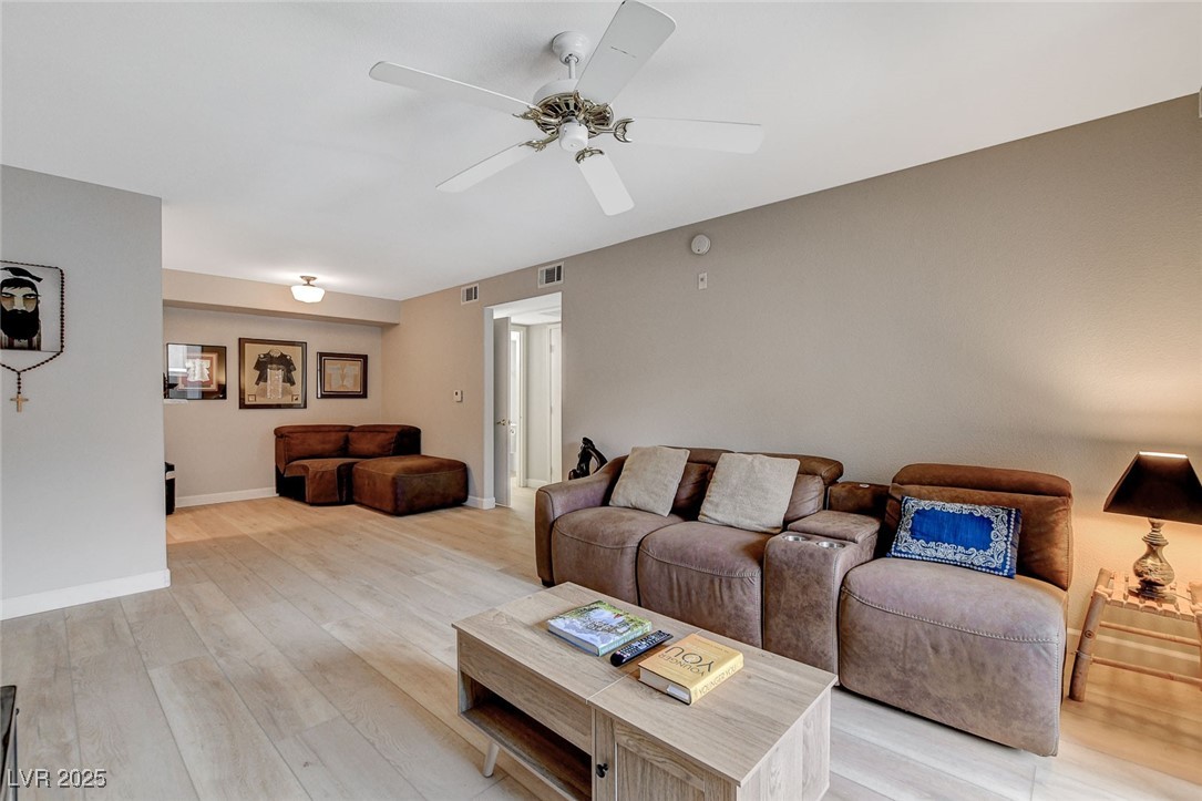 555 East Silverado Ranch Boulevard, Unit 1172 Las Vegas, NV 89183 - Photo 6 of 29 Living room with light wood finished floors and ceiling fan