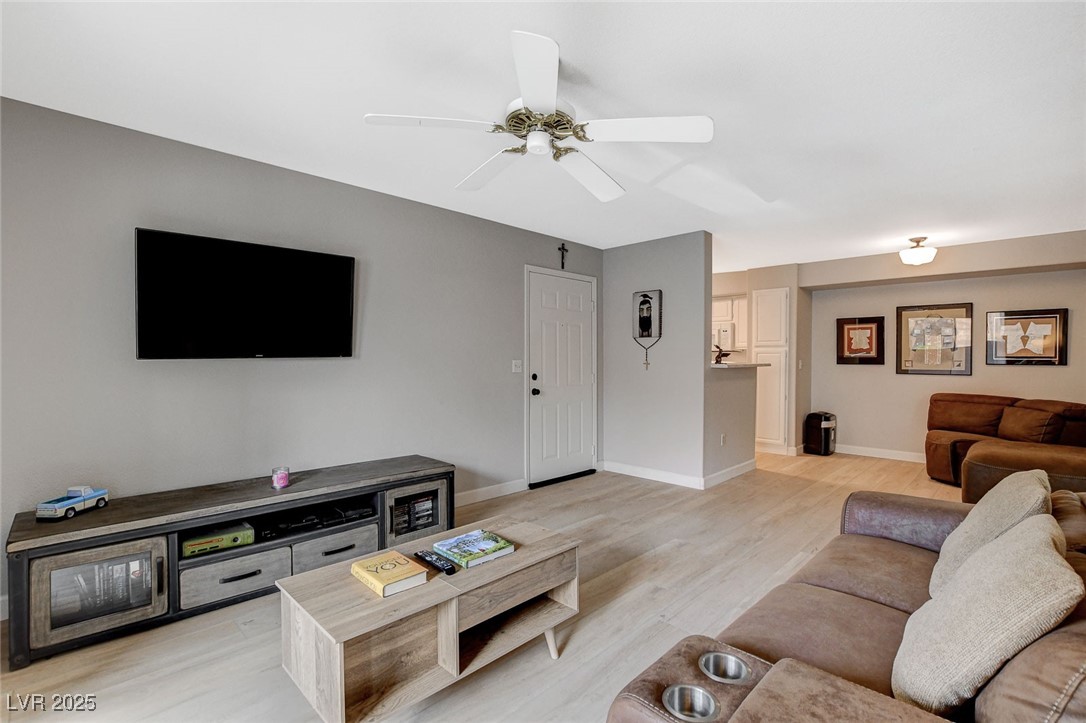 555 East Silverado Ranch Boulevard, Unit 1172 Las Vegas, NV 89183 - Photo 7 of 29 Living area with ceiling fan and light wood-style floors