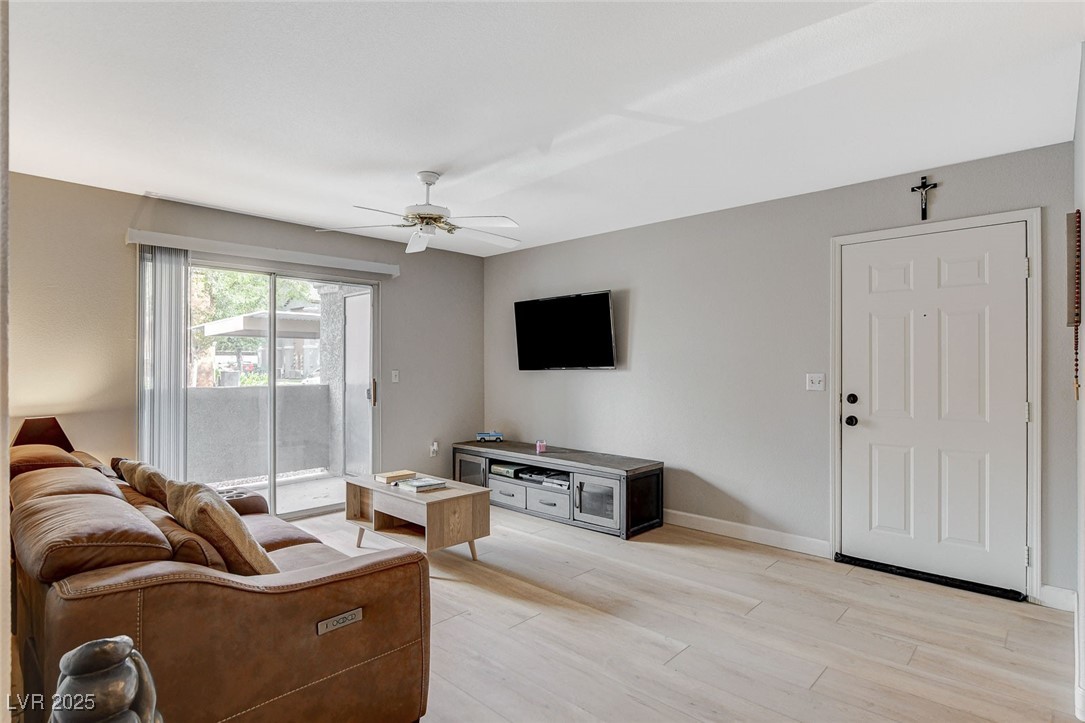 555 East Silverado Ranch Boulevard, Unit 1172 Las Vegas, NV 89183 - Photo 8 of 29 Living room featuring light wood finished floors and ceiling fan