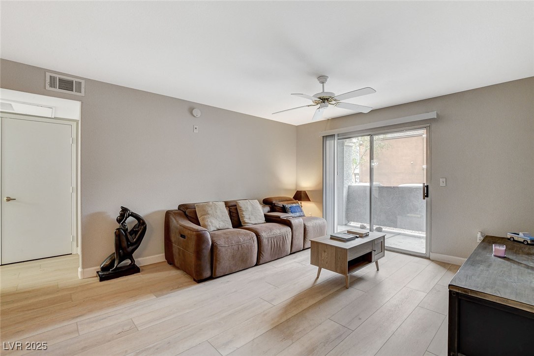 555 East Silverado Ranch Boulevard, Unit 1172 Las Vegas, NV 89183 - Photo 9 of 29 Living room with light wood-style floors and ceiling fan