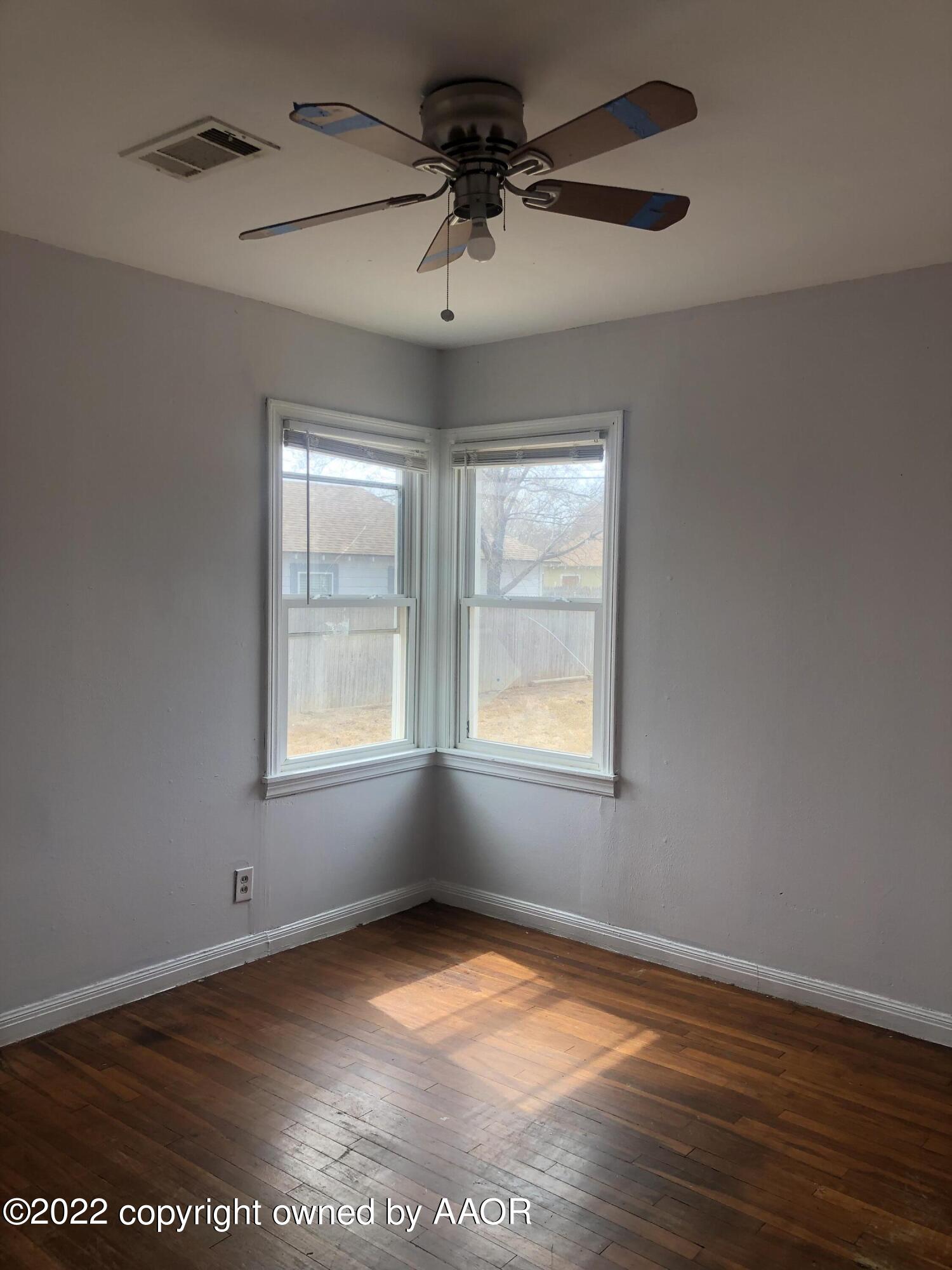 4110 South Polk Street Amarillo, TX 79110 - Photo 12 of 13 an empty room with a window and a ceiling fan