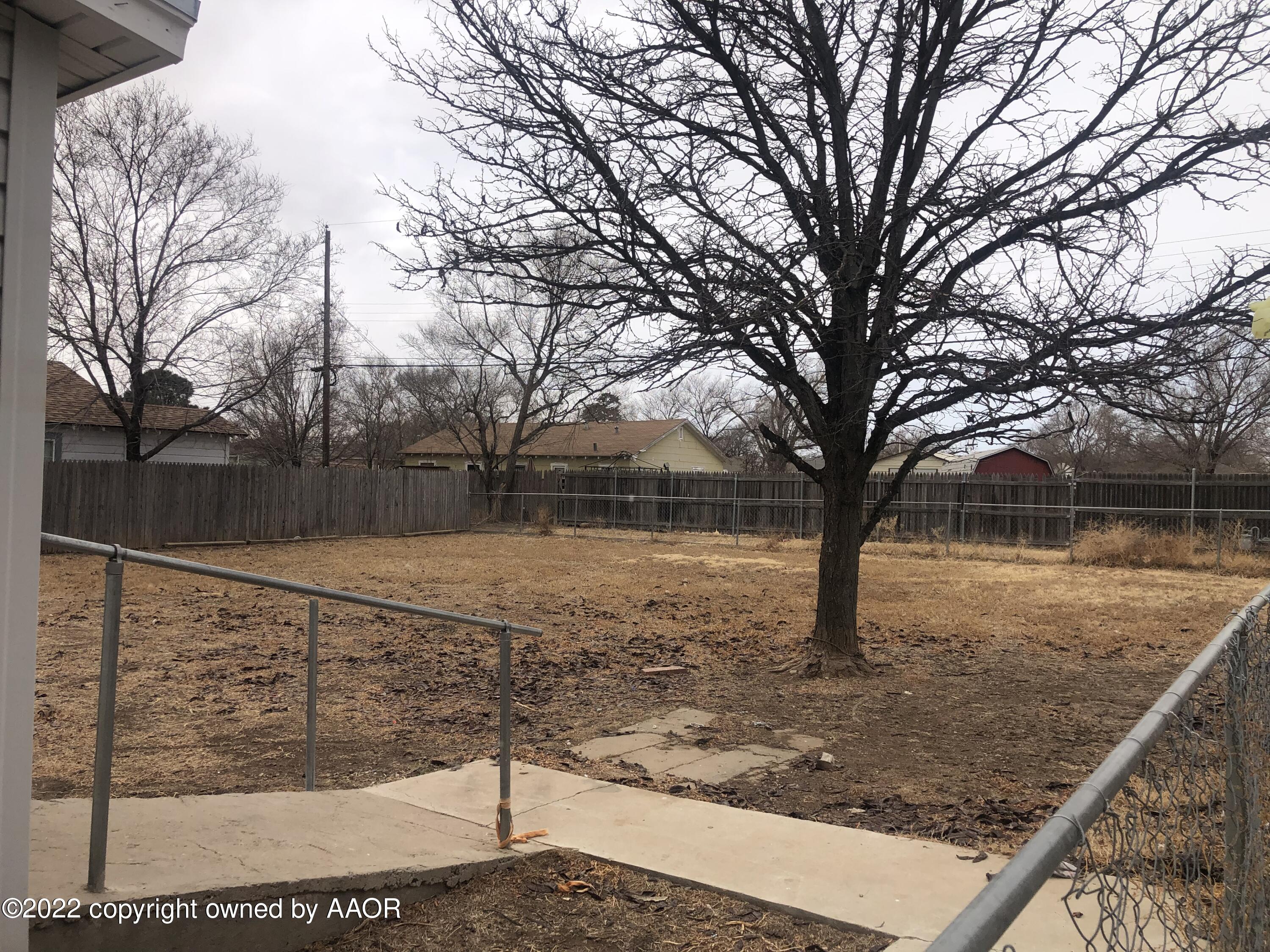 4110 South Polk Street Amarillo, TX 79110 - Photo 13 of 13 a view of a backyard with wooden fence