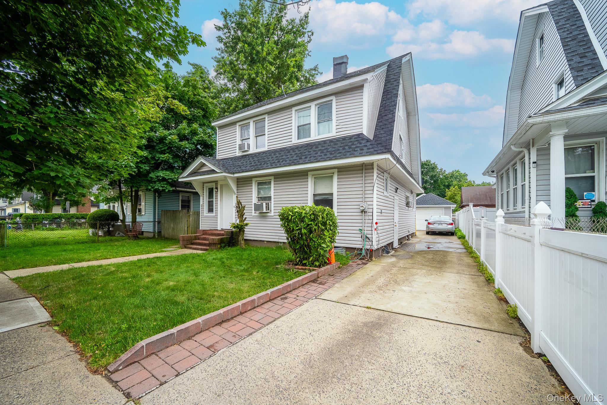 295 Washington Street Hempstead, NY 11550 - Photo 17 of 17 a view of a house with a yard and plants