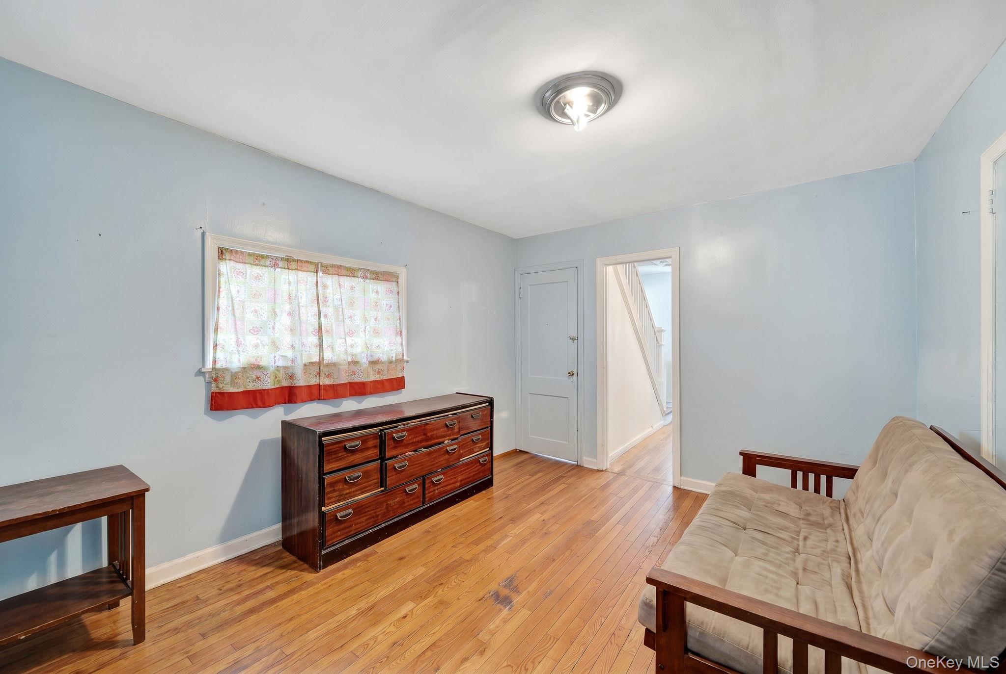 295 Washington Street Hempstead, NY 11550 - Photo 7 of 17 a living room with furniture and a window