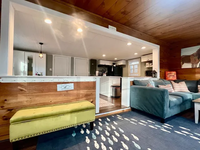 a living room with furniture and kitchen view