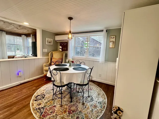 a dining room with furniture and wooden floor