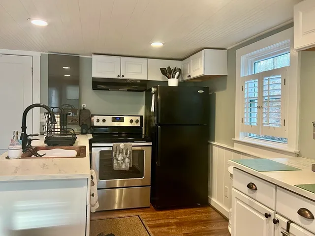 a kitchen with stainless steel appliances granite countertop a refrigerator and a sink