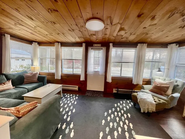 a living room with furniture and large windows