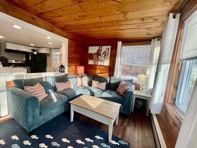 a living room with furniture a rug and a chandelier
