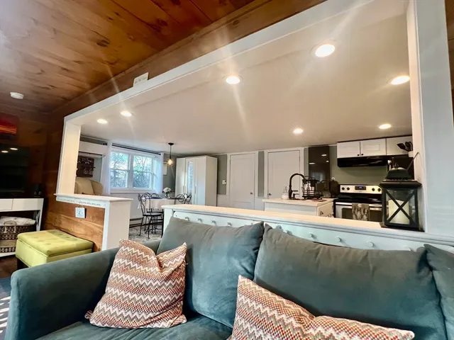 a living room with furniture and kitchen view