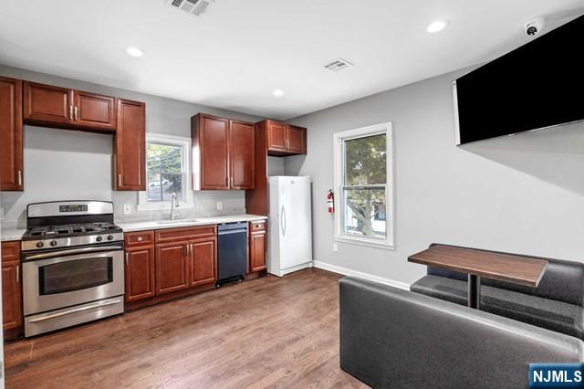 541 Union Avenue Paterson, NJ 07522 - Photo 21 of 28 a kitchen with stainless steel appliances granite countertop a stove a sink and a microwave
