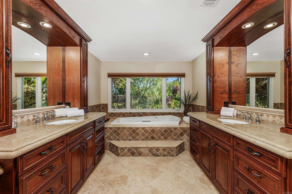 16346 Via Del Alba Rancho Santa Fe, CA 92067 - Photo 16 of 34 a spacious bathroom with a sink and a large mirror