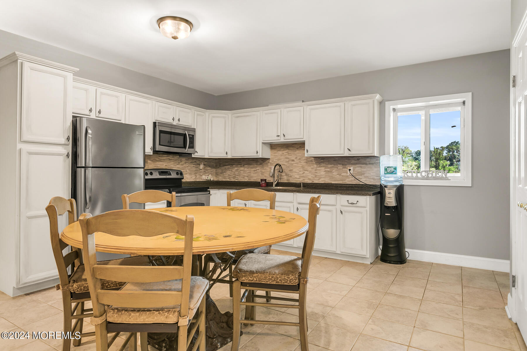 1 Eagle Nest Road Colts Neck, NJ 07722 - Photo 52 of 68 a kitchen with a dining table chairs and refrigerator