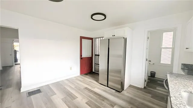 a view of a livingroom with wooden floor and staircase