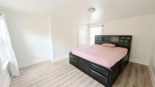 a bed room with a bed and wooden floor