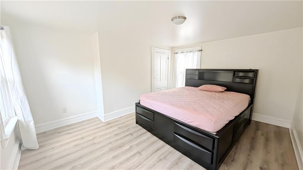 735 Boquet Street McKees Rocks, PA 15136 - Photo 14 of 30 a bed room with a bed and wooden floor