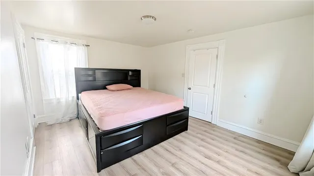 a bedroom with a bed and a mirror