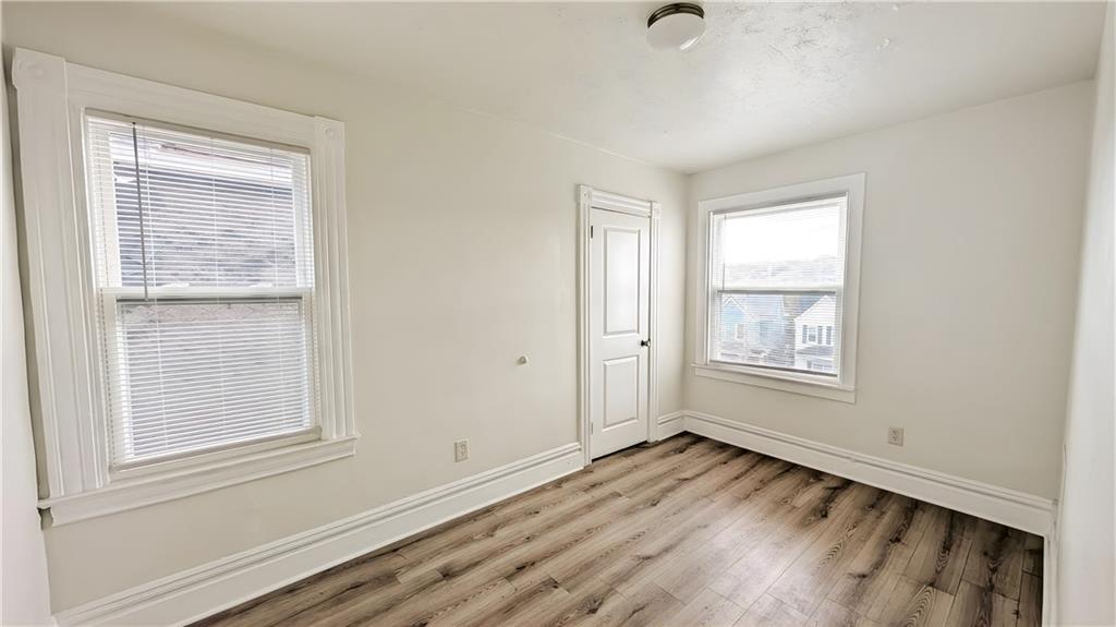 735 Boquet Street McKees Rocks, PA 15136 - Photo 18 of 30 a view of an empty room with wooden floor and a window