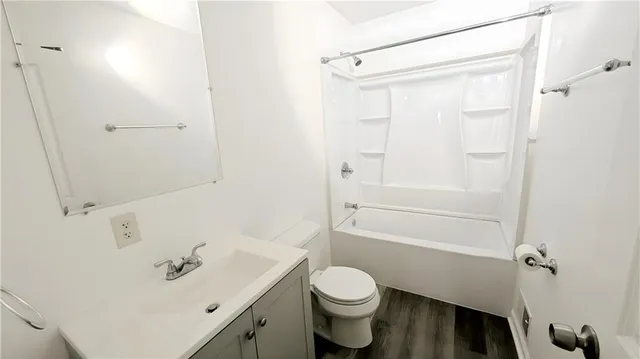 a bathroom with a sink a toilet and a window