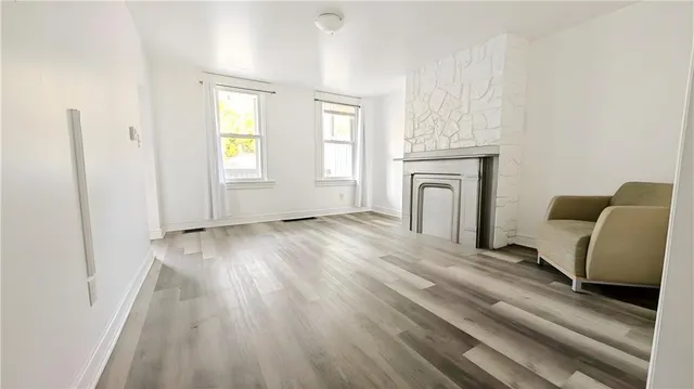 a view of a livingroom with furniture wooden floor and window