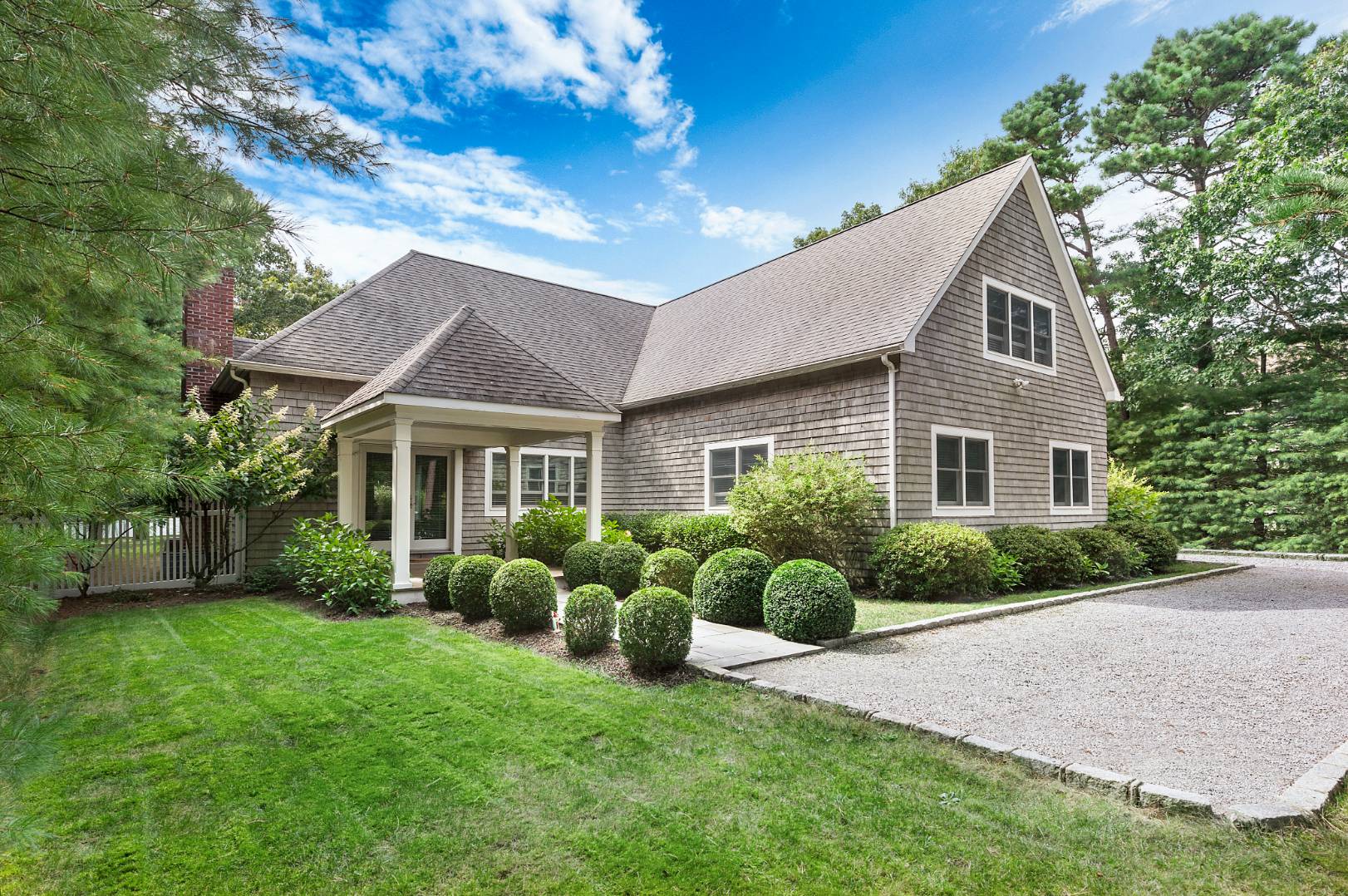 25 East Gate Road Wainscott, NY 11975 - Photo 1 of 13 a front view of house with yard and green space
