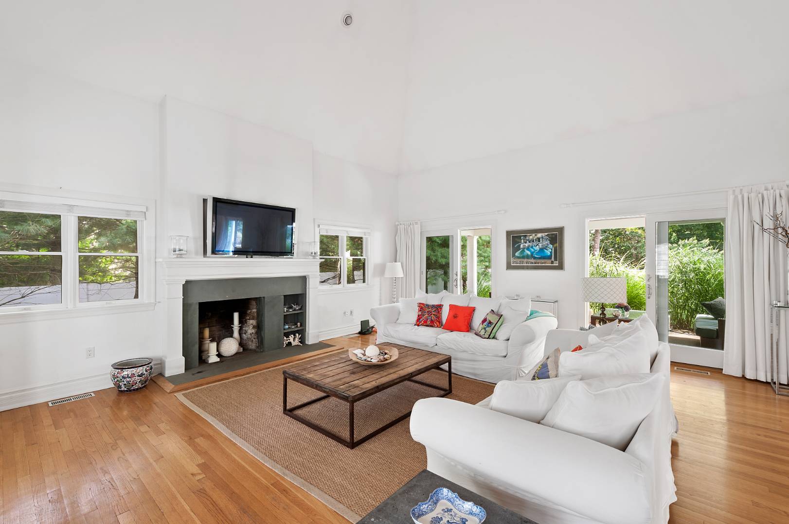 25 East Gate Road Wainscott, NY 11975 - Photo 4 of 13 a living room with furniture and a fireplace