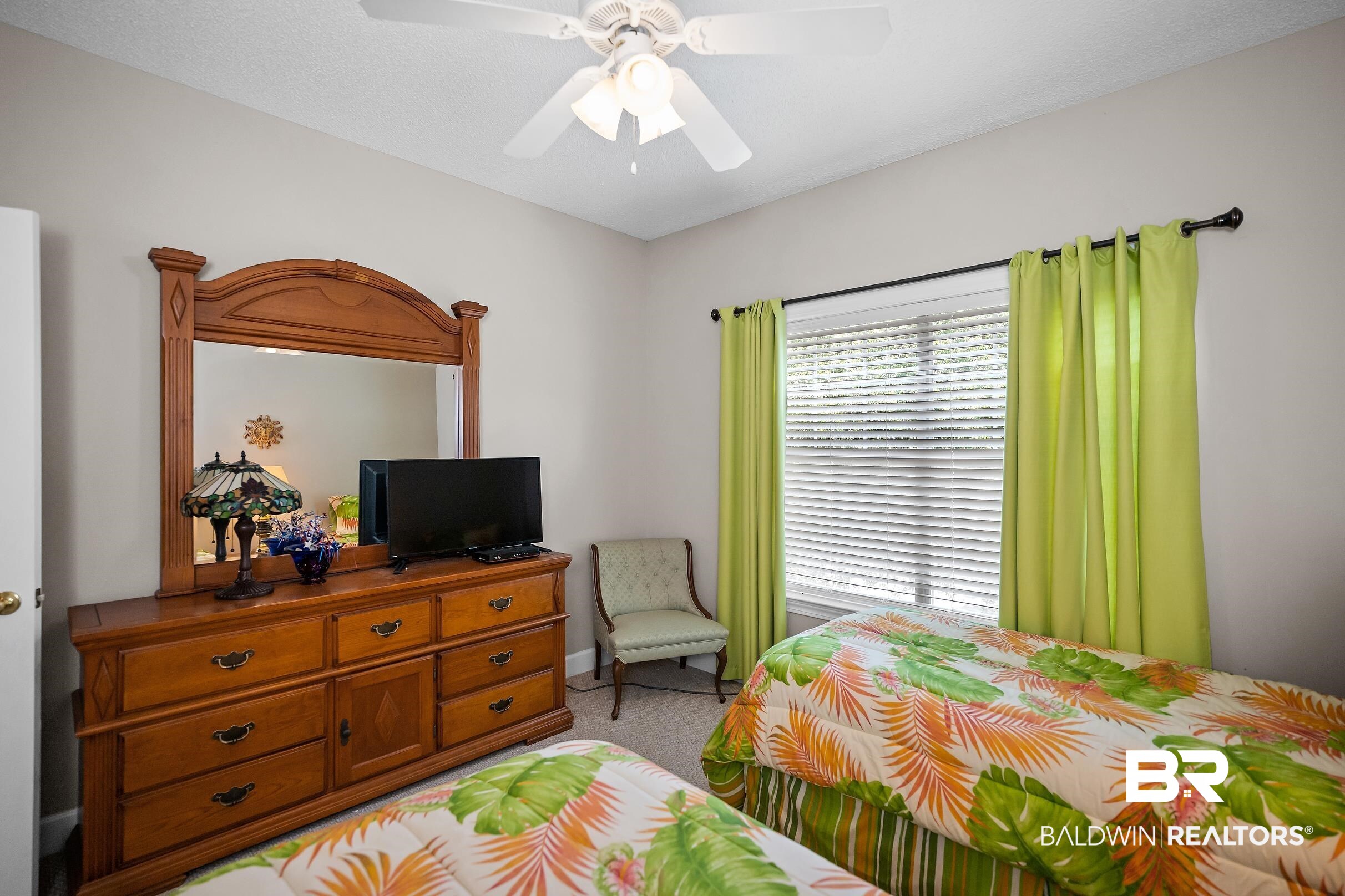 430 West Fort Morgan Road, Unit 704 Gulf Shores, AL 36542 - Photo 23 of 35 Bedroom featuring a window with horizontal blinds, light-colored walls, and a ceiling fan with integrated lighting