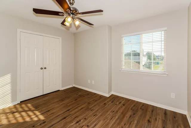 wooden floor in an empty room with a window