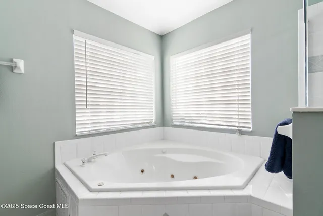a bathroom with a granite countertop double vanity sink and a mirror